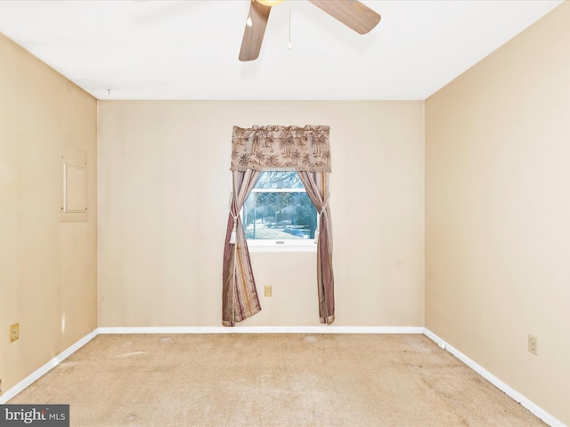 spare room featuring carpet flooring, a ceiling fan, and baseboards