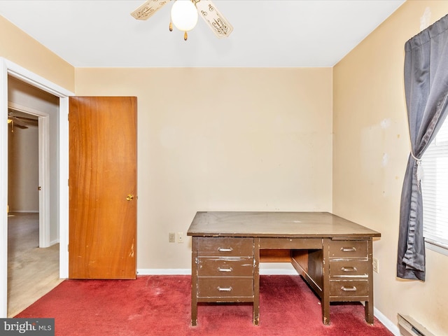 unfurnished office with a ceiling fan, baseboards, dark colored carpet, and a baseboard radiator