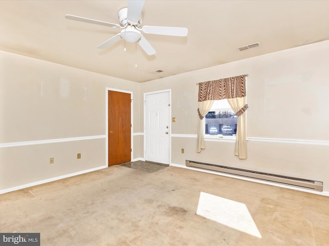 unfurnished room with visible vents, a baseboard heating unit, baseboards, ceiling fan, and carpet floors