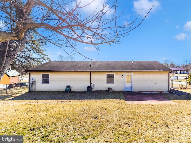 back of house with a lawn, cooling unit, and a patio