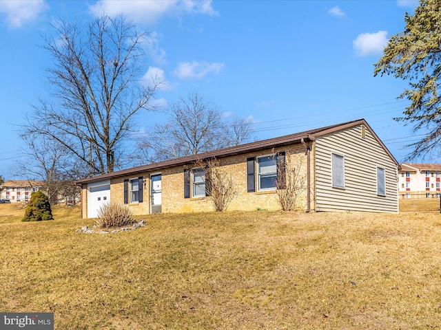 single story home with brick siding, an attached garage, a front lawn, and fence