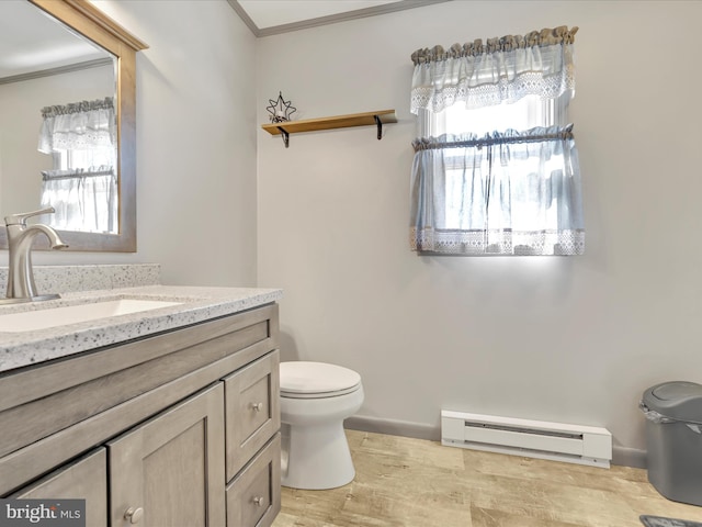 bathroom featuring vanity, wood finished floors, a baseboard radiator, crown molding, and toilet