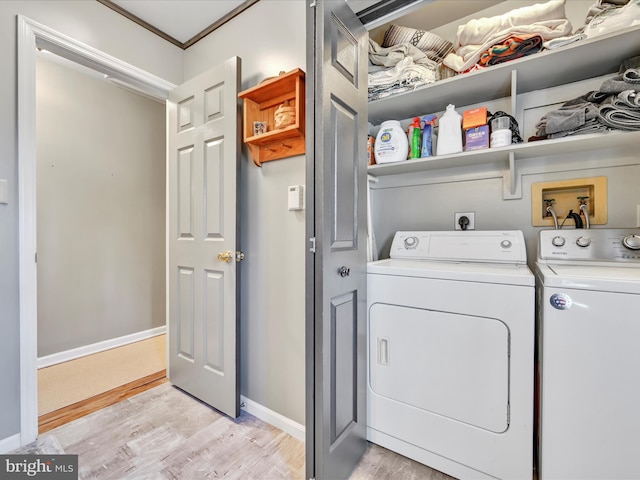 laundry room with washer and clothes dryer, laundry area, baseboards, and light wood-style floors