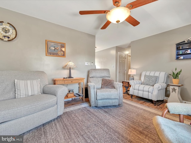 living room featuring wood finished floors and a ceiling fan