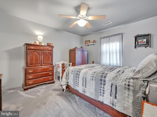 bedroom featuring light carpet, visible vents, and ceiling fan