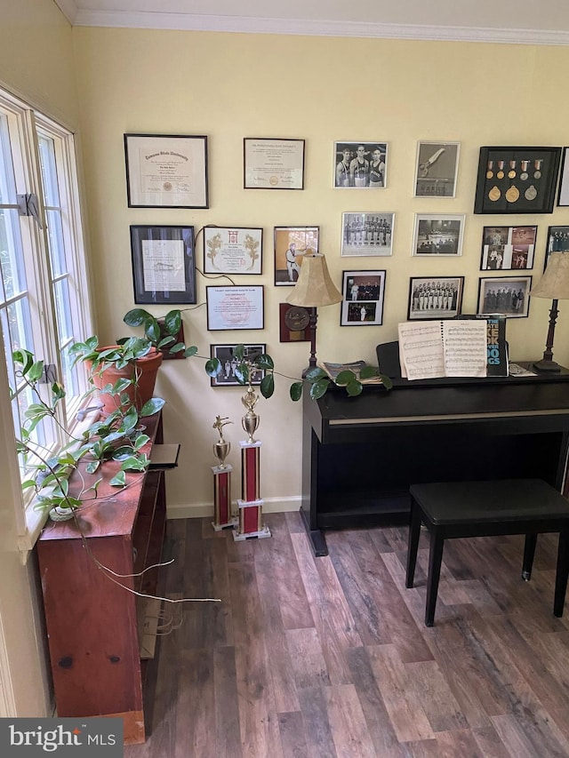 sitting room with wood finished floors, baseboards, and ornamental molding