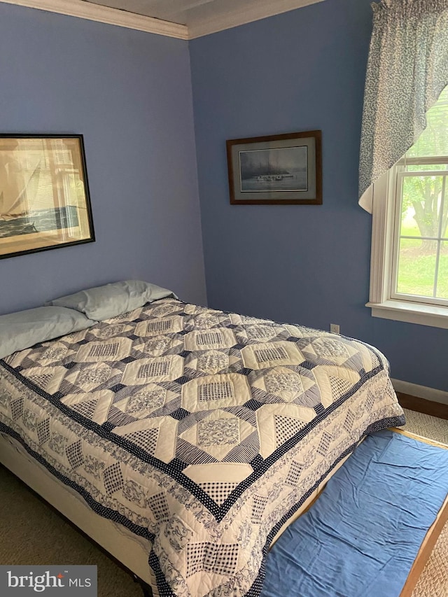 bedroom featuring carpet flooring, baseboards, and ornamental molding