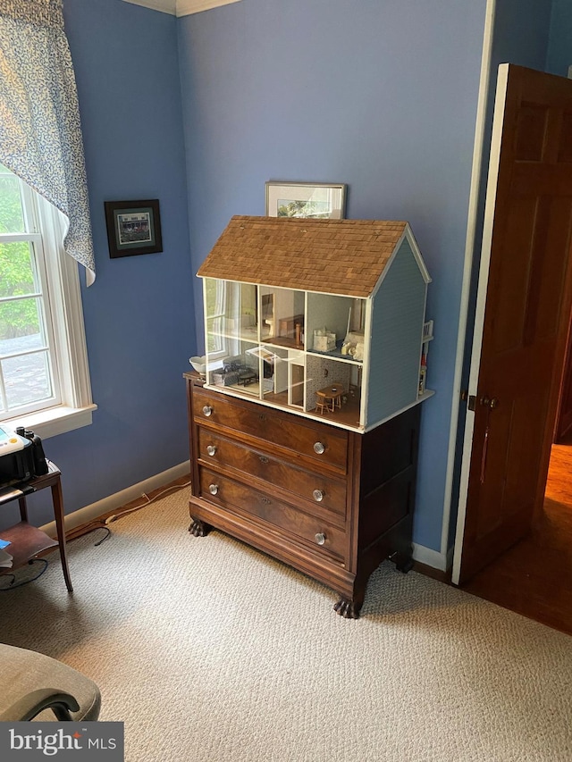 bedroom featuring light carpet and baseboards