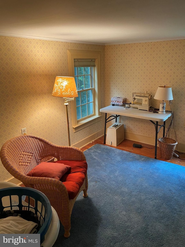 sitting room with wallpapered walls, wood finished floors, and baseboards