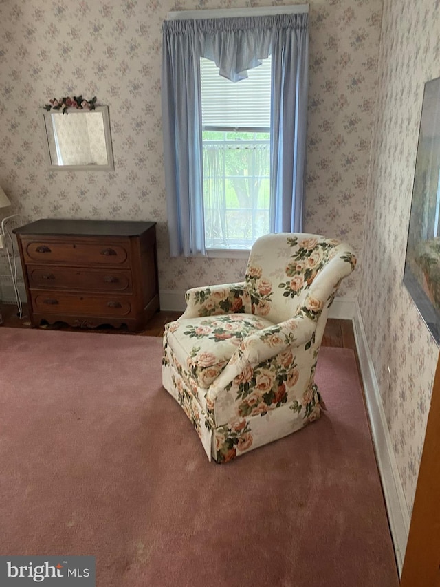 living area with wallpapered walls and baseboards