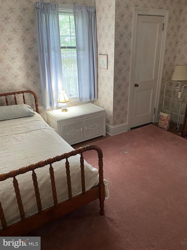 bedroom featuring wallpapered walls, radiator, and carpet flooring