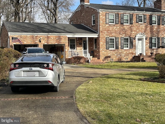 view of front of house featuring a chimney, concrete driveway, a front lawn, a garage, and brick siding