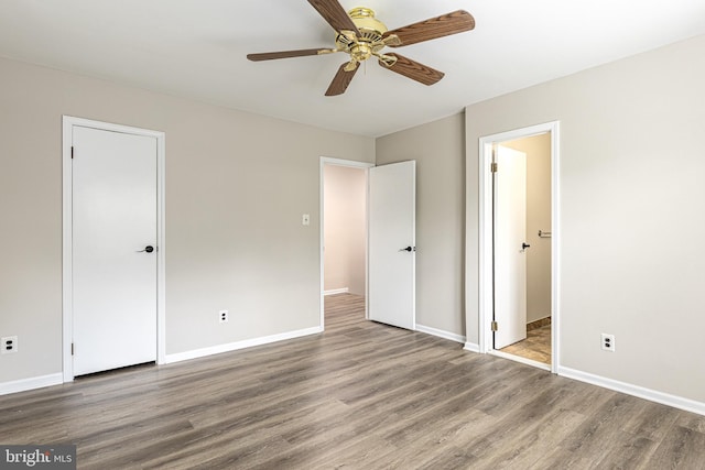 unfurnished bedroom with baseboards and wood finished floors