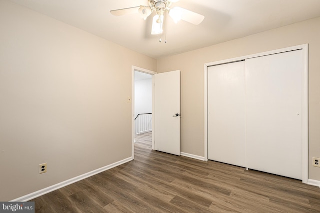 unfurnished bedroom with a closet, baseboards, and wood finished floors