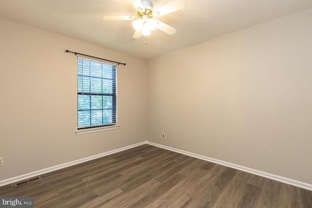 unfurnished room featuring ceiling fan, visible vents, baseboards, and dark wood finished floors