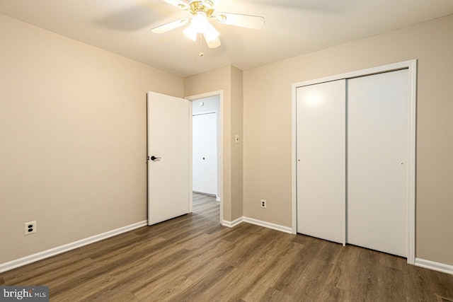 unfurnished bedroom with ceiling fan, a closet, baseboards, and wood finished floors