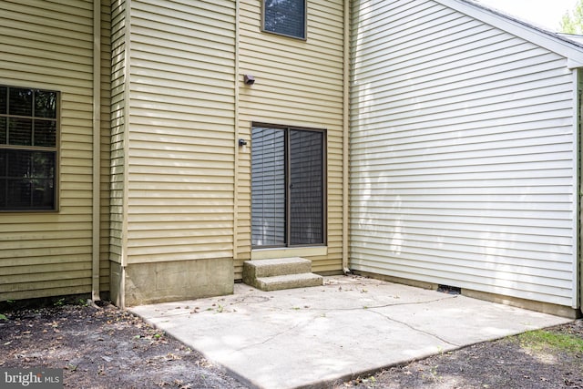 entrance to property featuring a patio area