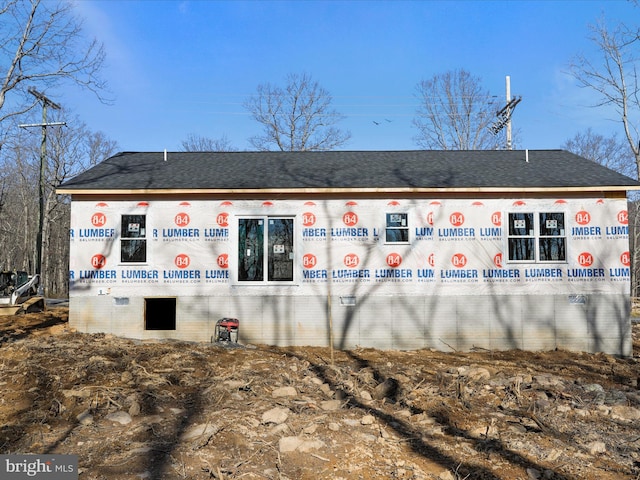 rear view of house featuring brick siding