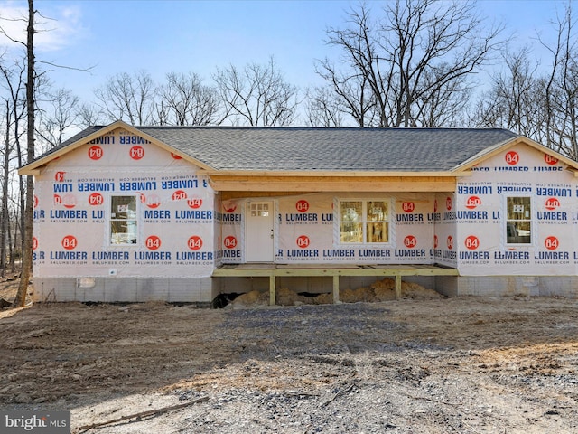 property in mid-construction featuring a shingled roof