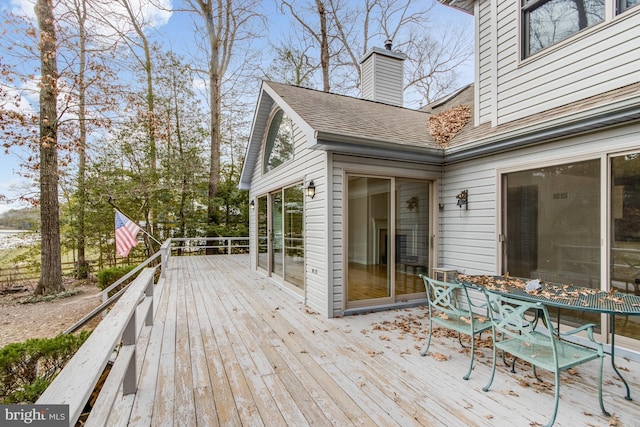 wooden terrace with outdoor dining area