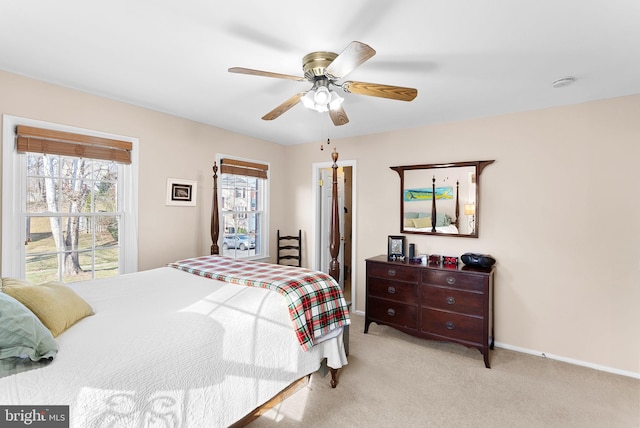 bedroom featuring ceiling fan, baseboards, and light carpet