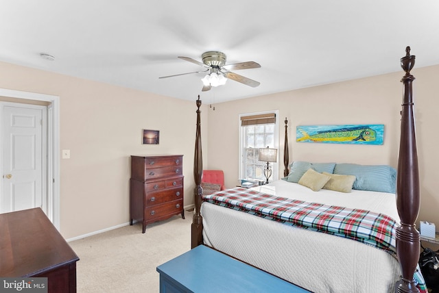 bedroom with a ceiling fan, light colored carpet, and baseboards