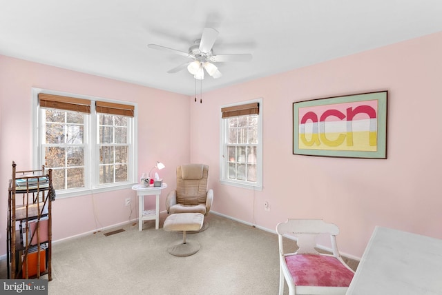 living area featuring a ceiling fan, carpet, visible vents, and baseboards