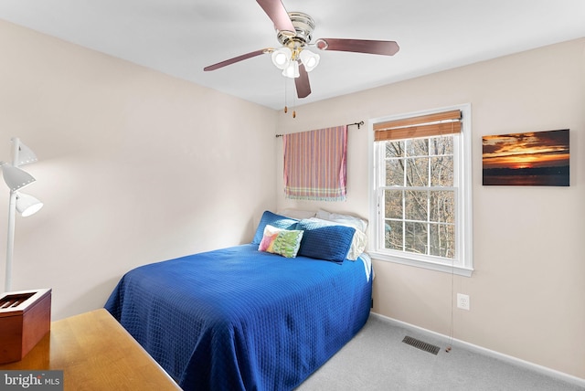 bedroom with visible vents, baseboards, carpet, and a ceiling fan