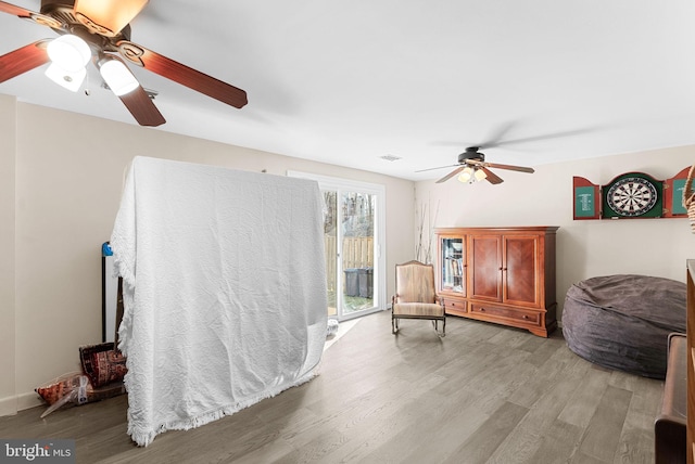 living area with visible vents and light wood-style floors