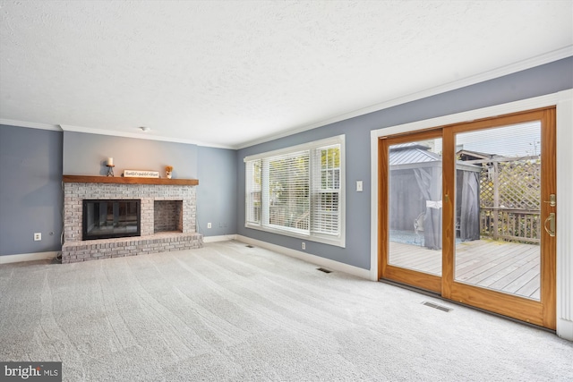 unfurnished living room featuring a textured ceiling, carpet, baseboards, ornamental molding, and visible vents