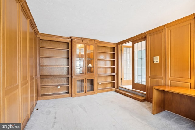 unfurnished living room with light colored carpet