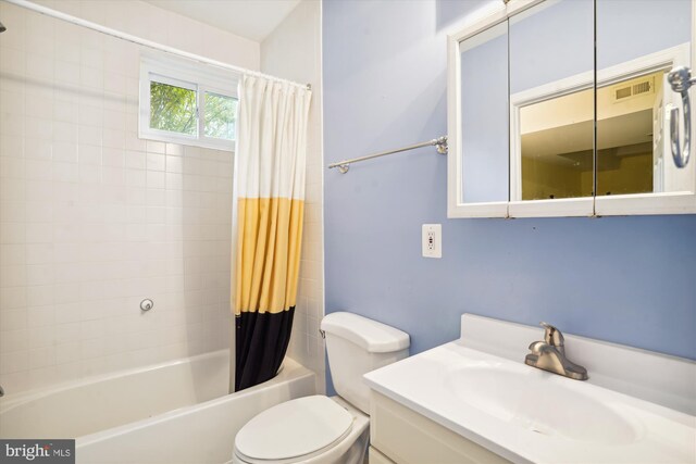 bathroom with shower / bath combination with curtain, visible vents, vanity, and toilet