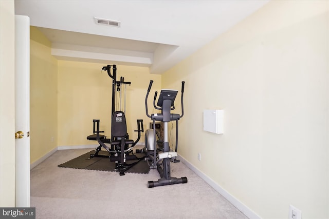 exercise room with visible vents, carpet flooring, and baseboards