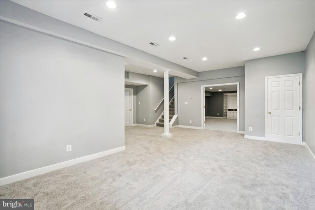 finished below grade area with recessed lighting, stairway, visible vents, carpet floors, and baseboards