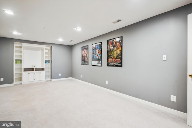 below grade area with baseboards, visible vents, recessed lighting, and light colored carpet