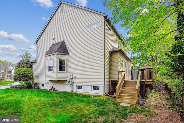 back of house featuring a yard, stairs, and a deck