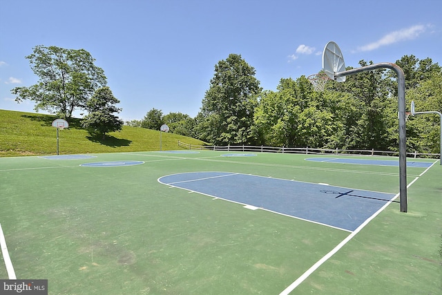 view of basketball court with community basketball court and a lawn