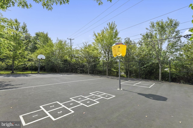 view of basketball court with community basketball court and fence
