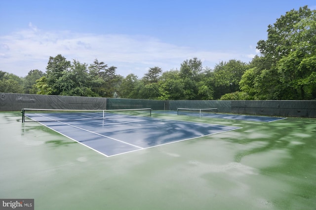 view of sport court featuring fence