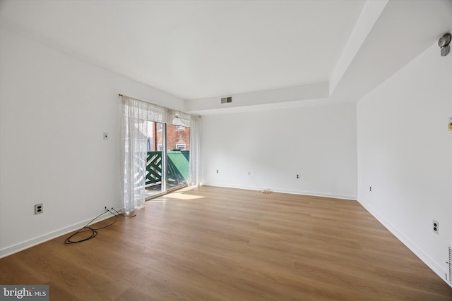 spare room with visible vents, baseboards, and light wood-style flooring