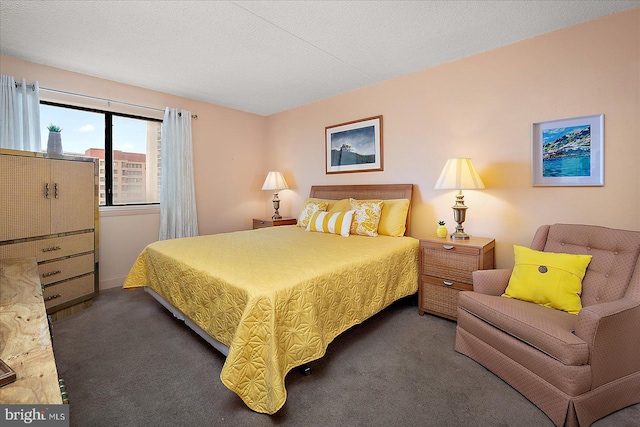 bedroom with carpet floors and a textured ceiling