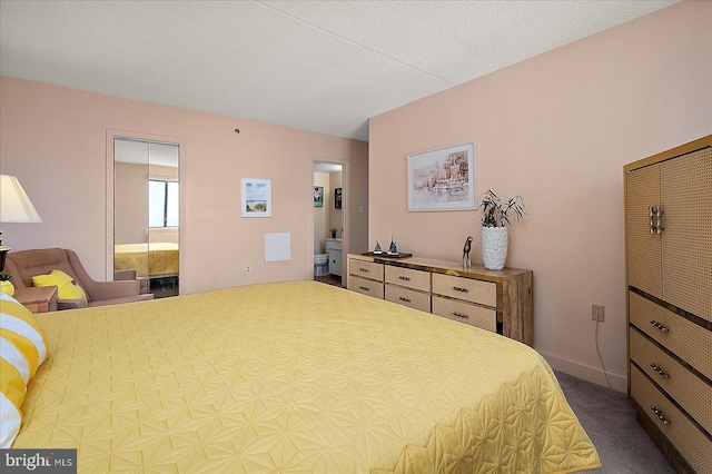 bedroom featuring a textured ceiling, baseboards, and carpet floors