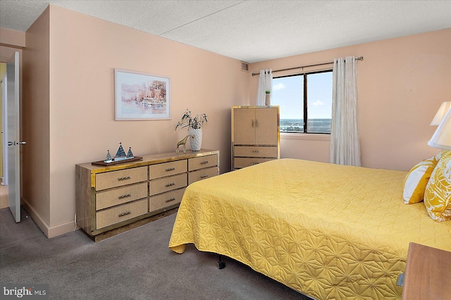 bedroom with carpet flooring, baseboards, visible vents, and a textured ceiling