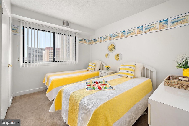 carpeted bedroom with baseboards, visible vents, and a textured ceiling