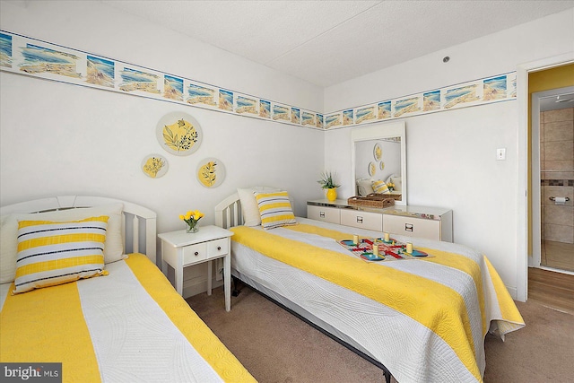 bedroom featuring carpet floors and a textured ceiling