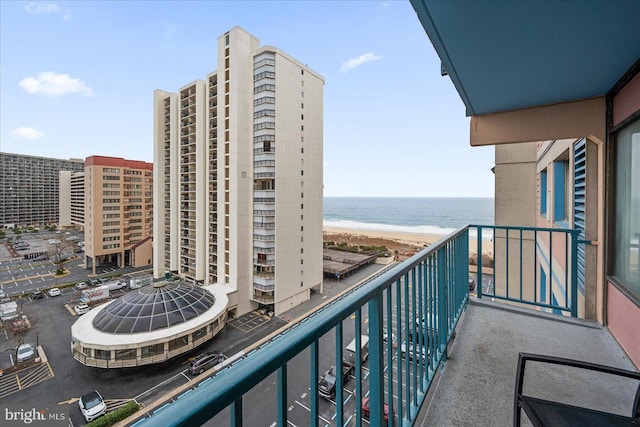 balcony featuring a water view and a view of the beach