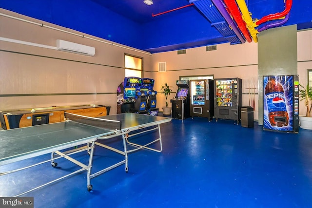 playroom with visible vents, an AC wall unit, and concrete flooring