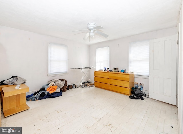 misc room with light wood-style floors and a ceiling fan