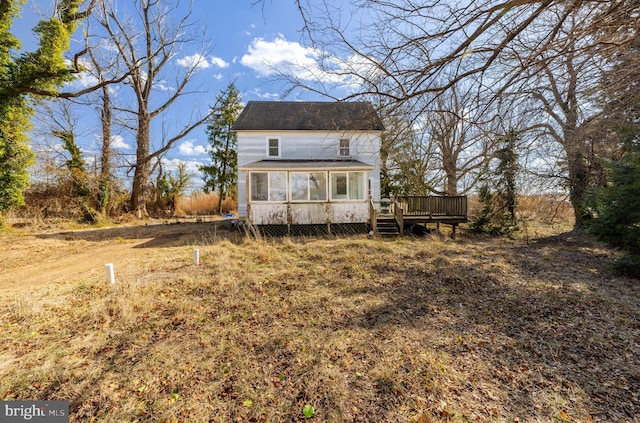 back of property with a wooden deck