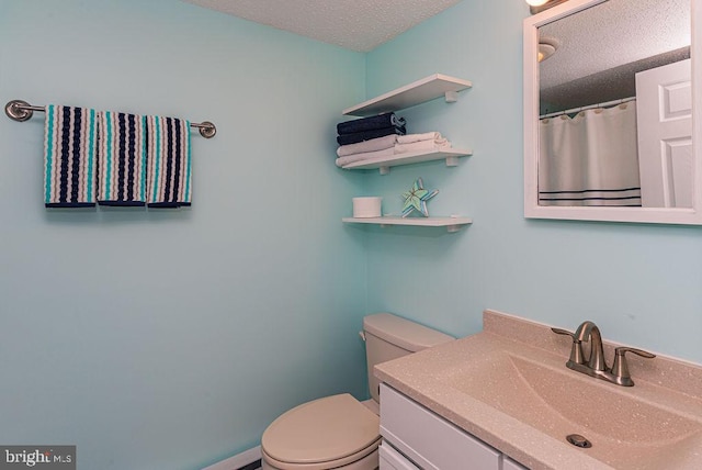 full bath featuring a textured ceiling, toilet, and vanity